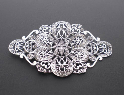 Silver and marcasita brooch with a flower in the middle
